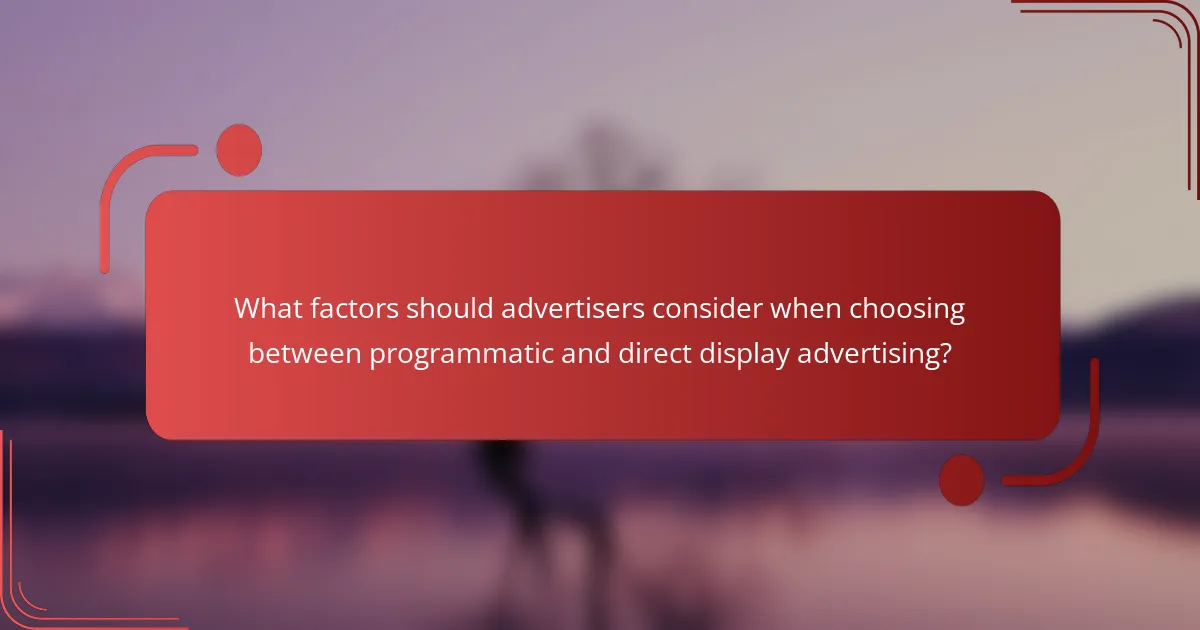 What factors should advertisers consider when choosing between programmatic and direct display advertising?